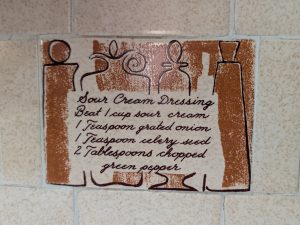 Vintage recipe tile preserved as an original architectural detail in an older home
