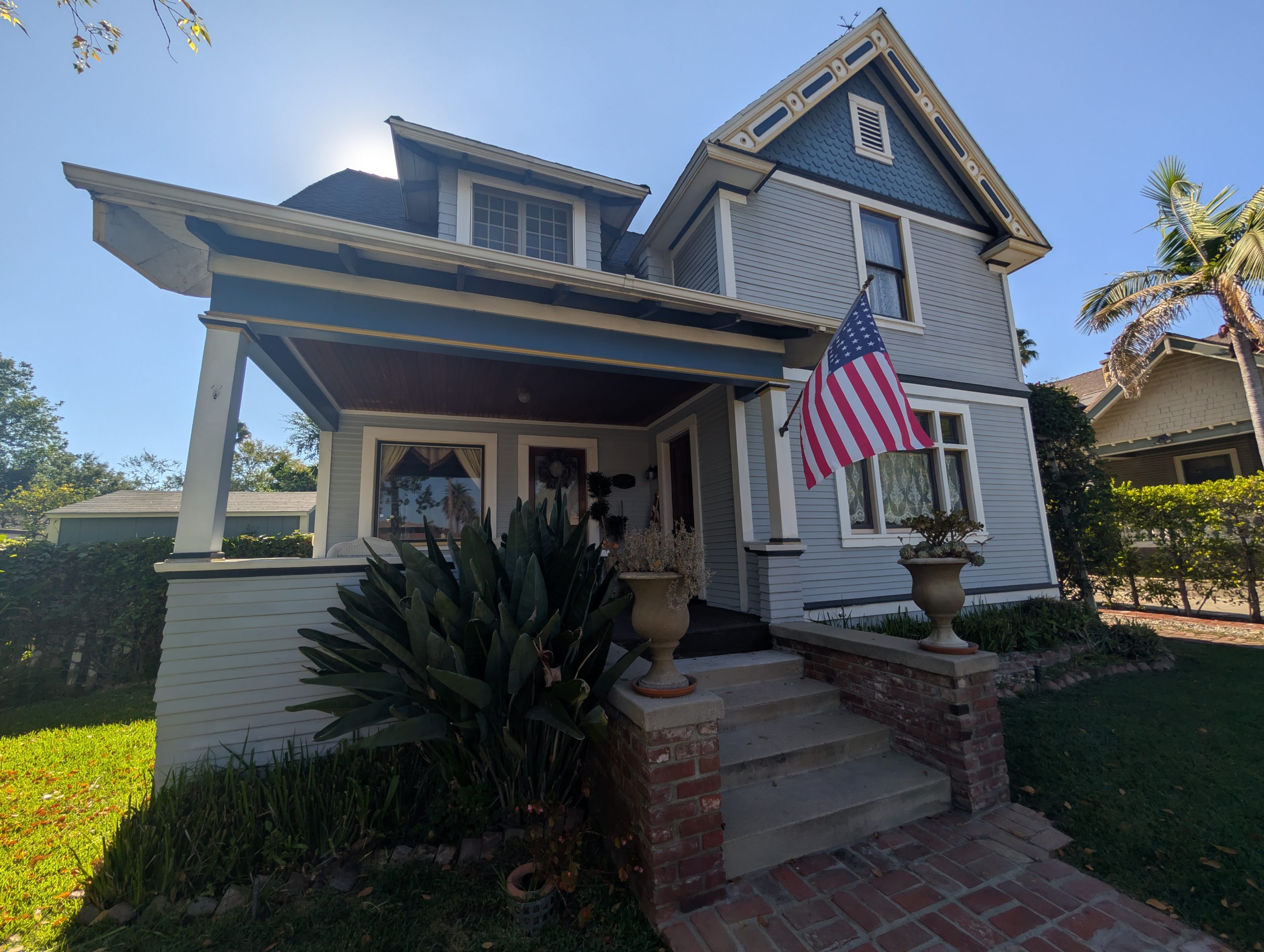 Two-story historic character home with front porch, wood siding, and decorative gable